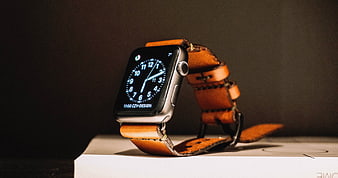 Smartwatch with Leather Strap on White Surface