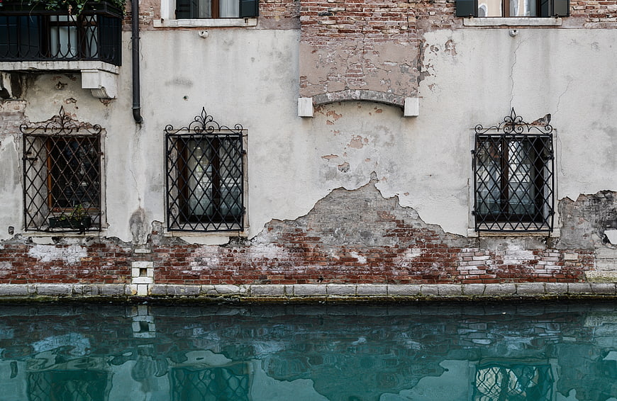 Weathered Venice Canal Facade with Iron Grilles