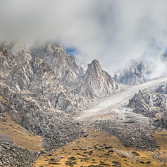 Misty Rocky Mountain Peaks with Autumnal Foreground