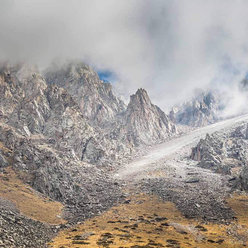 Misty Rocky Mountain Peaks with Autumnal Foreground