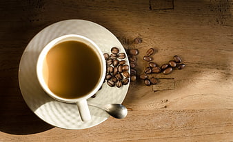 Top View Coffee Cup with Beans on Wooden Table