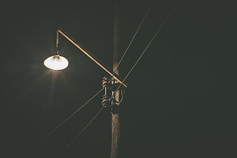 Vintage Street Lamp on Wooden Pole at Night