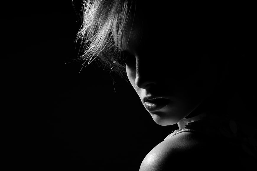 Dramatic Black and White Portrait of a Woman in Shadow