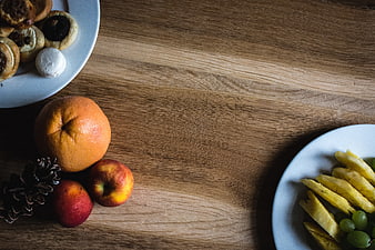 Top view of fresh fruit and pastries on wooden table