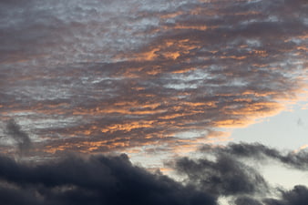 Dramatic sunset clouds with orange and gray tones