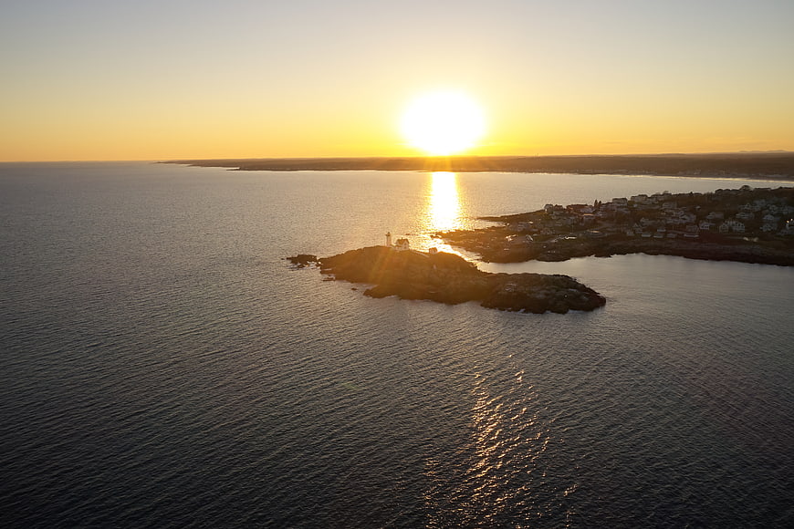 Aerial View of Coastal Lighthouse at Golden Sunset
