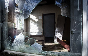 Broken Window Looking Into Abandoned House Interior
