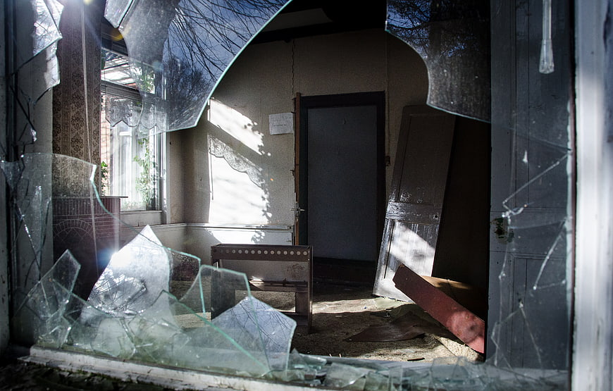 Broken Window Looking Into Abandoned House Interior