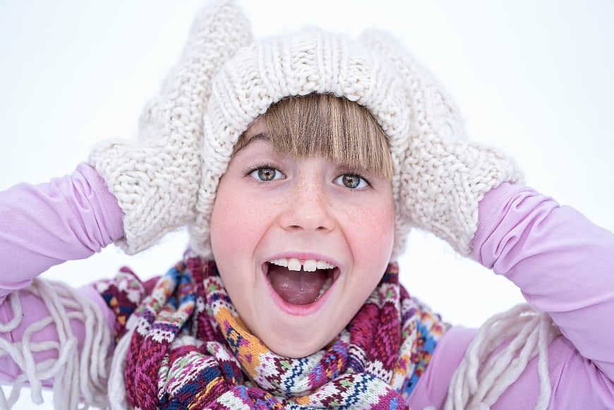 Excited Girl in Winter Hat and Scarf Close Up