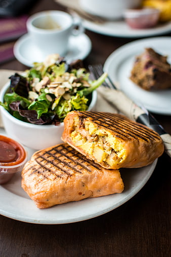 Grilled breakfast burrito with scrambled eggs and side salad