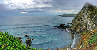 Dramatic coastal landscape with rocky cliffs and turquoise ocean