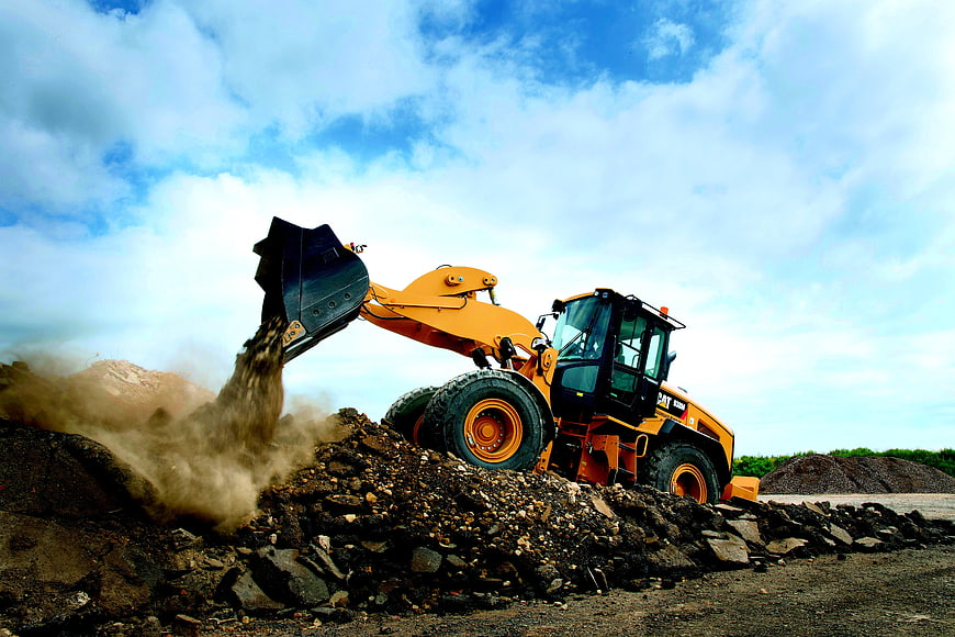 Yellow Wheel Loader Dumping Gravel on Construction Site