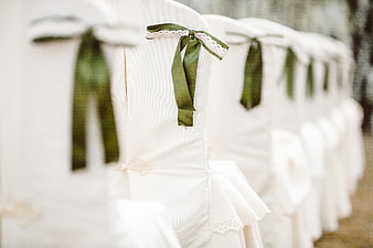 White Wedding Chairs with Green Ribbons and Lace Detail