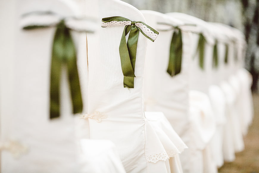 White Wedding Chairs with Green Ribbons and Lace Detail