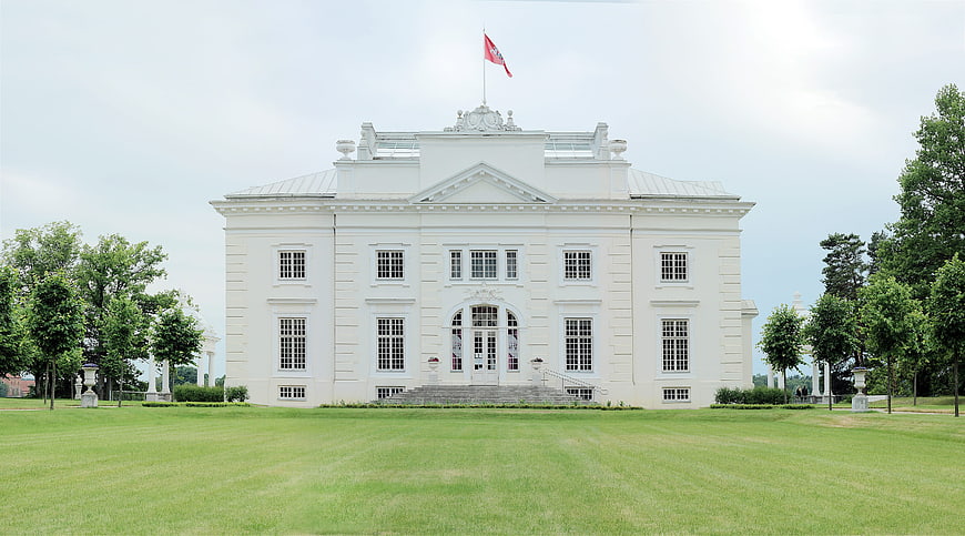 Grand White Baroque Palace with Green Lawn and Flag