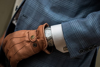 Close-up of man in blue plaid suit with leather gloves and watch