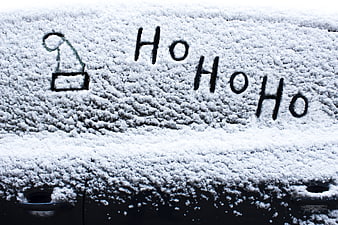 Ho Ho Ho Handwritten On Snowy Car Roof With Santa Hat Drawing