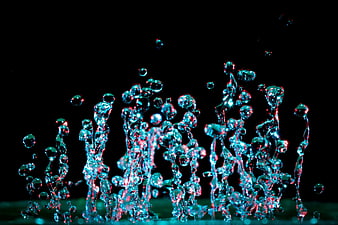 Abstract cyan and red water splash on black background