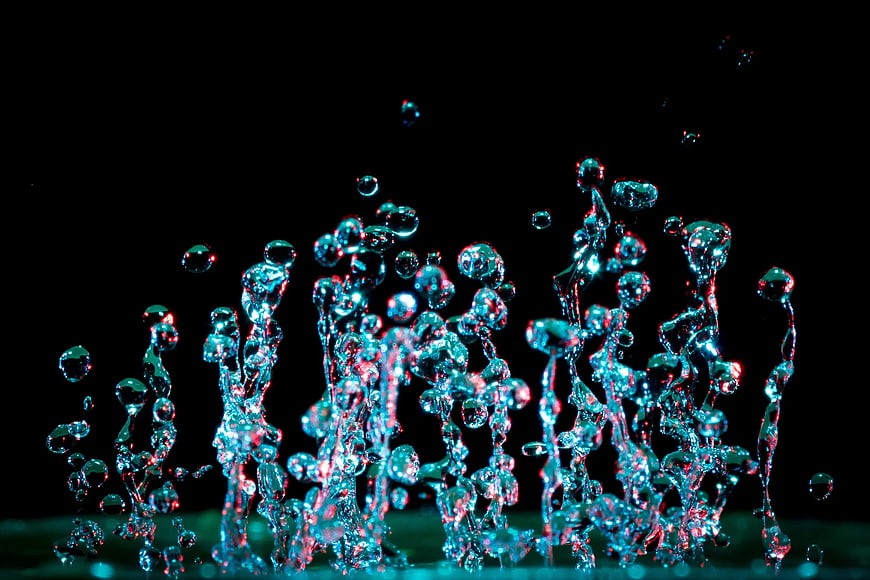 Abstract cyan and red water splash on black background