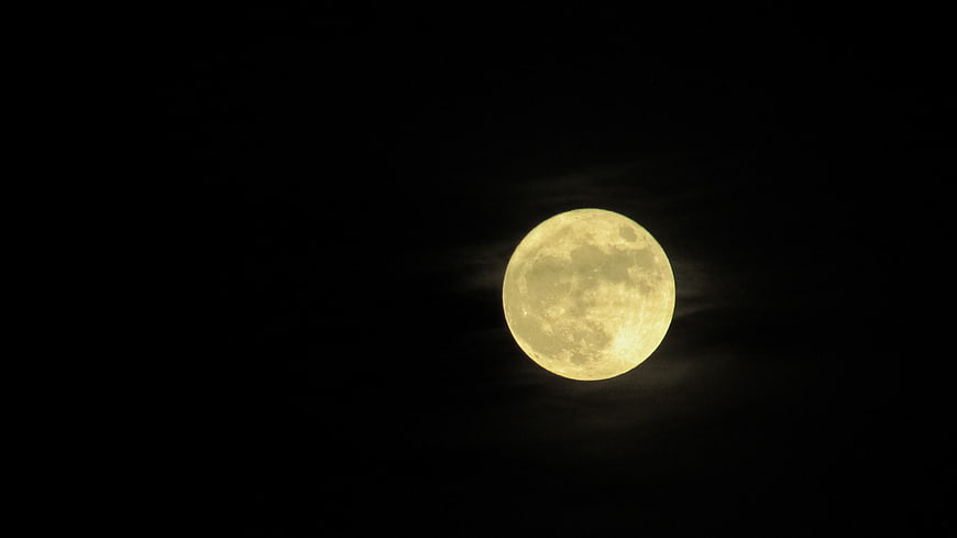 Full Moon In Night Sky With Wispy Clouds
