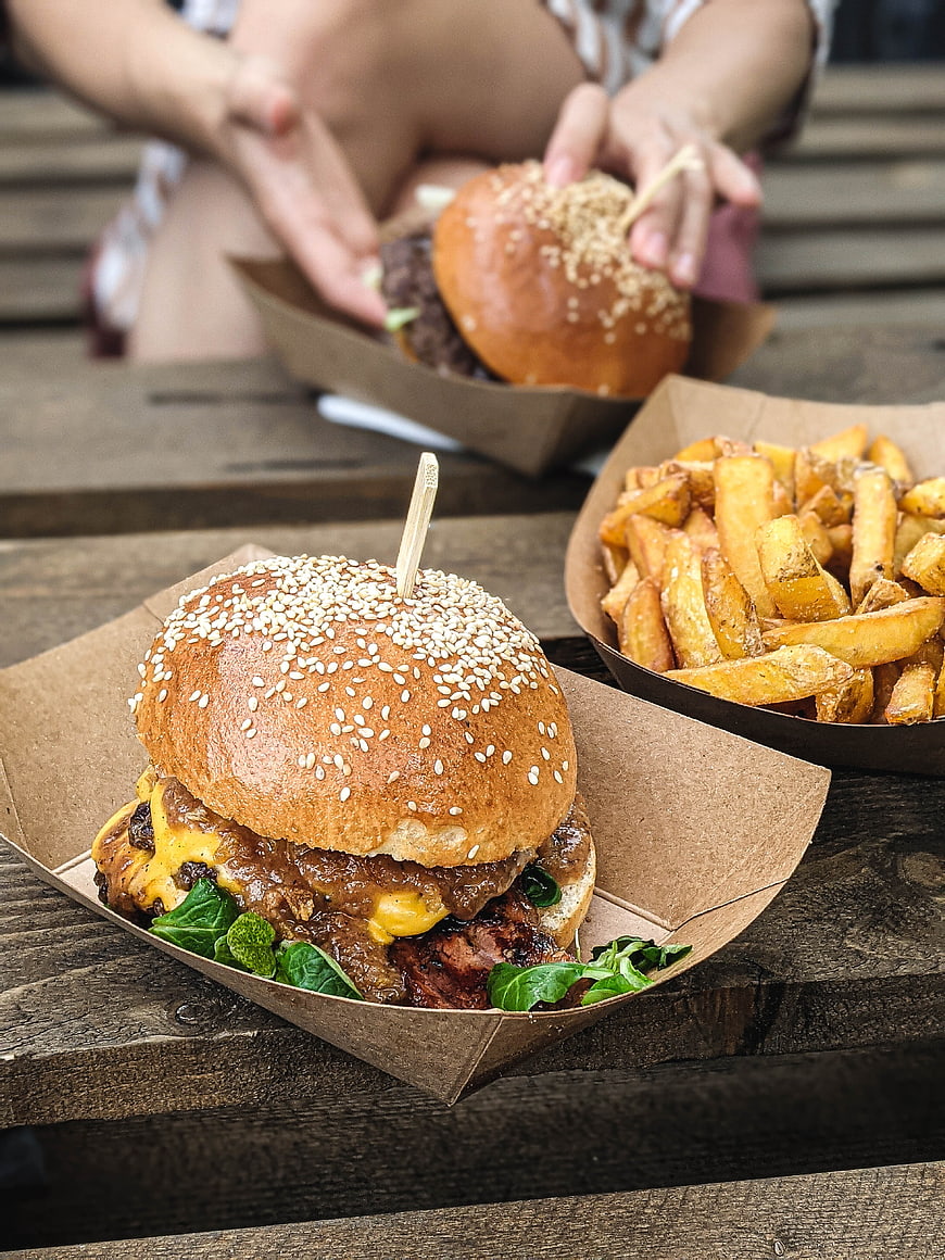 Delicious beef burger and fries on wooden table