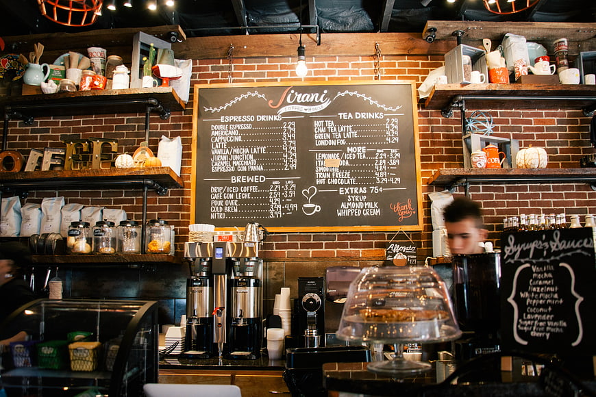 Coffee shop counter with menu board and espresso machines