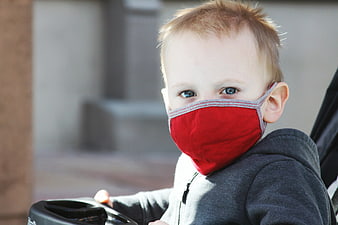 Toddler Boy Wearing Red Face Mask in Stroller