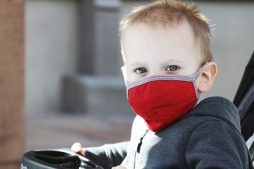 Toddler Boy Wearing Red Face Mask in Stroller