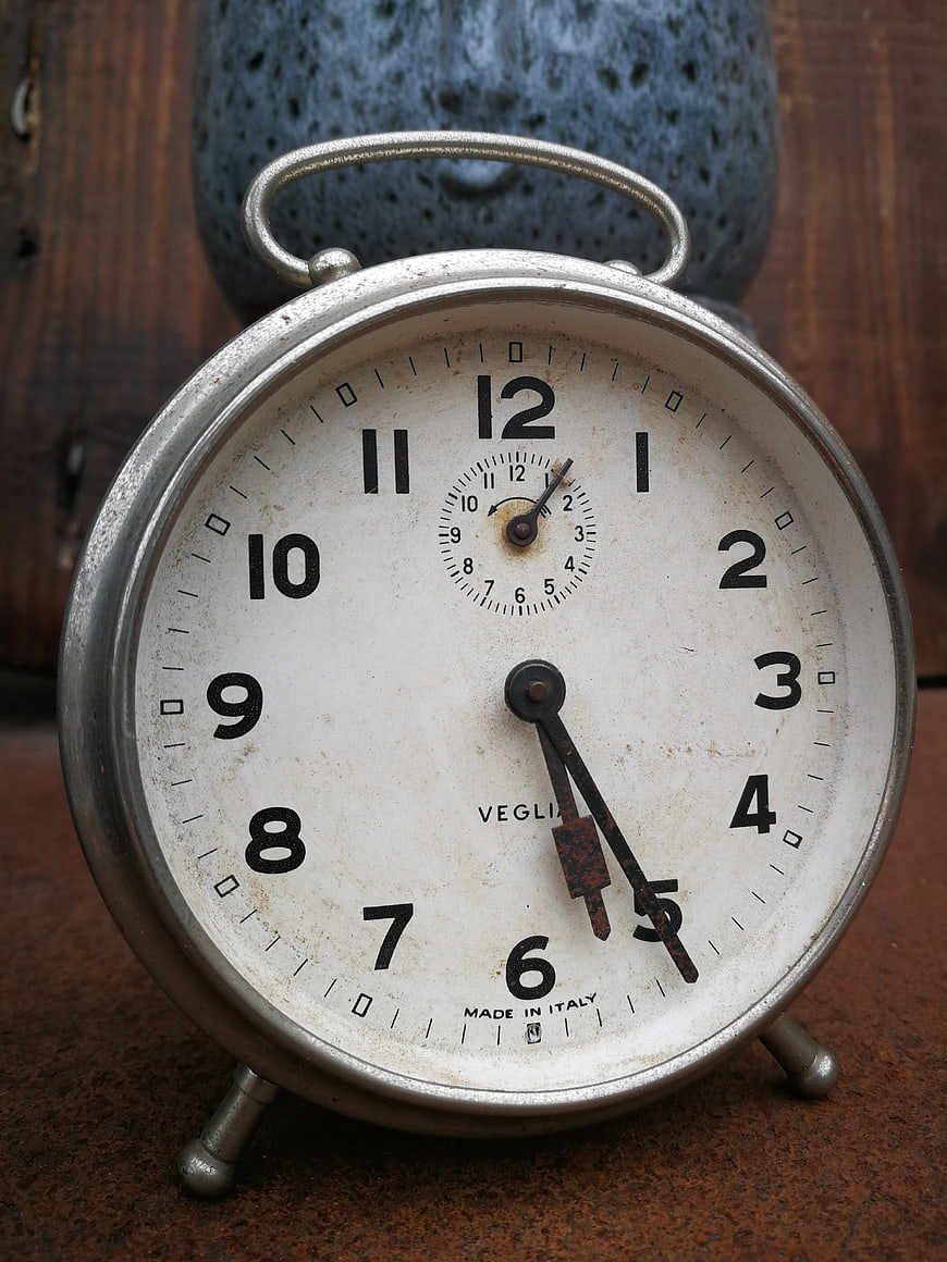 Vintage Veglia Alarm Clock on Rusty Surface