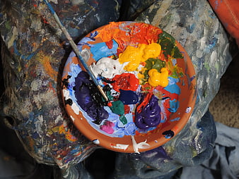 Close-up of artist palette with vibrant oil paints and brush