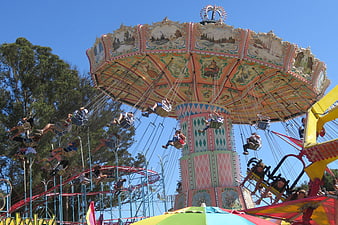 Colorful carnival swing ride with people flying high