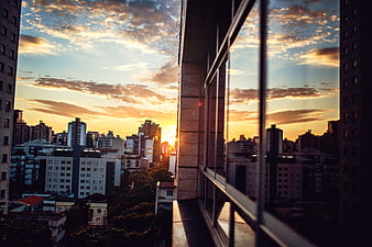 Sunset Cityscape View Through Apartment Window