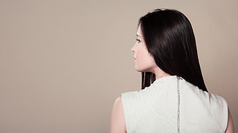 Side Profile of Woman with Long Dark Hair in White Top