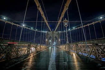 Night view of Brooklyn Bridge pedestrian walkway with lights