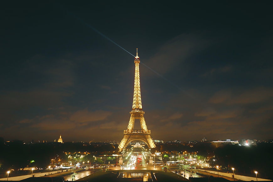 Eiffel Tower Illuminated at Night with Searchlights