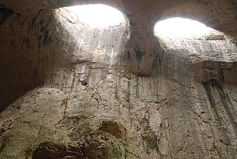 Interior View of Prohodna Cave with Natural Light Shafts
