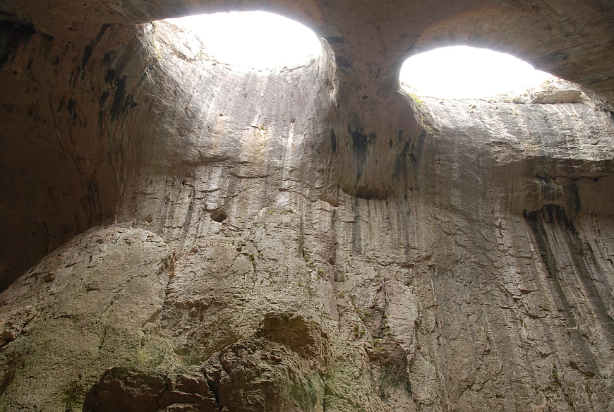 Interior View of Prohodna Cave with Natural Light Shafts