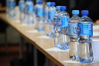 Row of plastic water bottles on a conference table