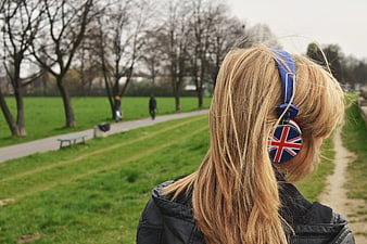 Woman with Union Jack Headphones in Park