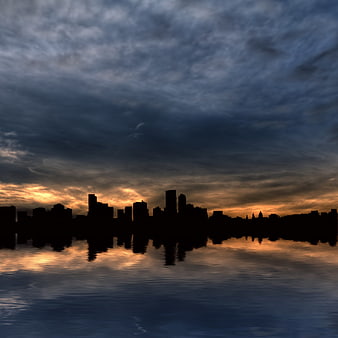 Dramatic City Skyline Silhouette Reflected in Water at Sunset