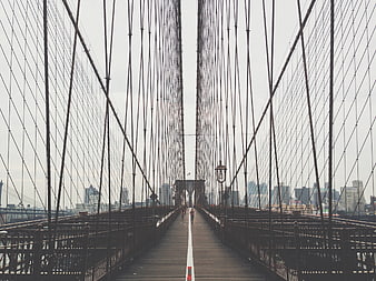 Symmetrical View of Brooklyn Bridge Walkway with Runners