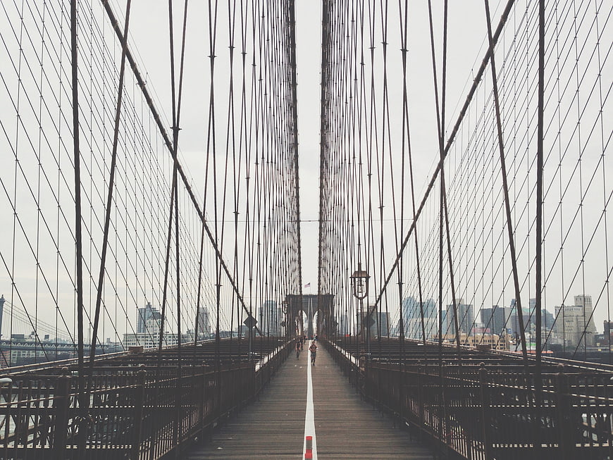 Symmetrical View of Brooklyn Bridge Walkway with Runners