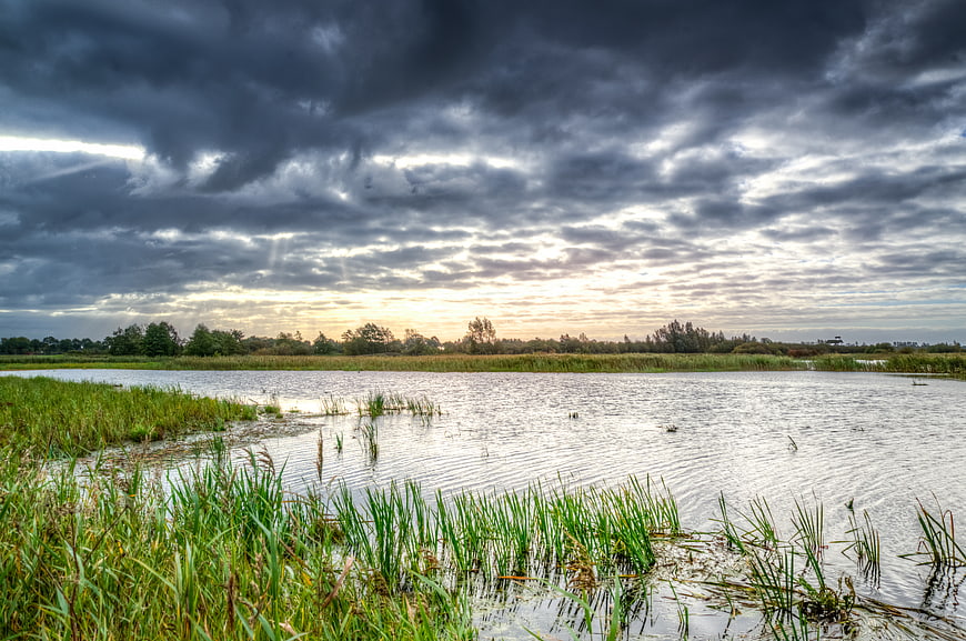 Dramatic Stormy Sky Over Marshland at Sunset