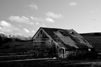 Weathered wooden barn in rural countryside landscape