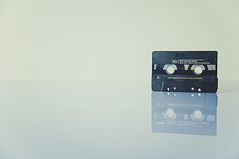 Vintage blue cassette tape with reflection on white background