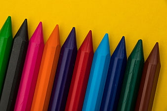 Colorful Crayons Arranged Diagonally On Bright Yellow Background