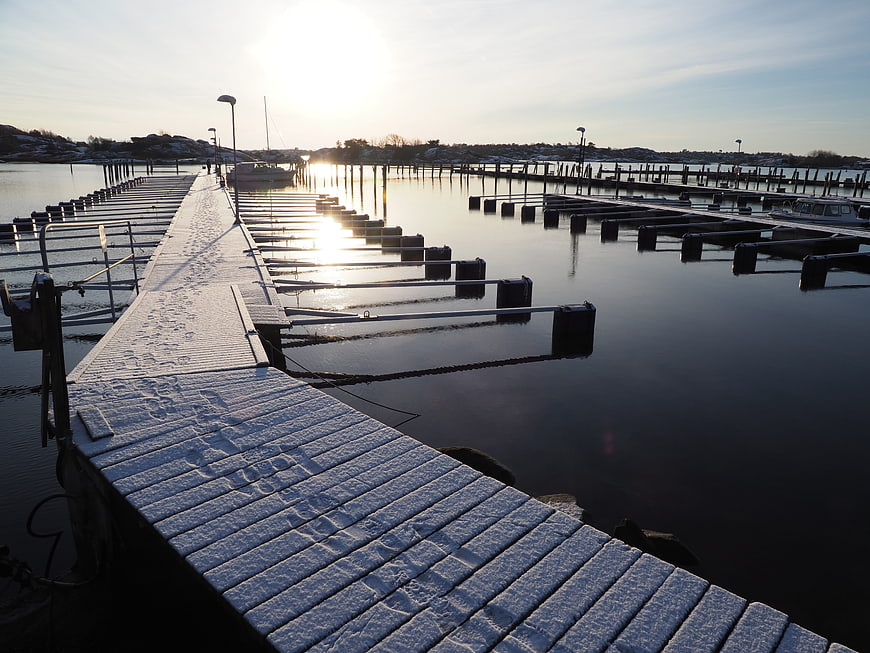 Snow-covered wooden pier at a quiet winter harbor