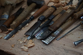 Vintage Woodworking Chisels and Tools on Wooden Workbench