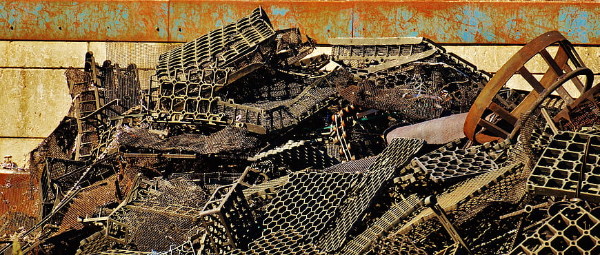 Pile of rusted scrap metal and industrial waste in junkyard