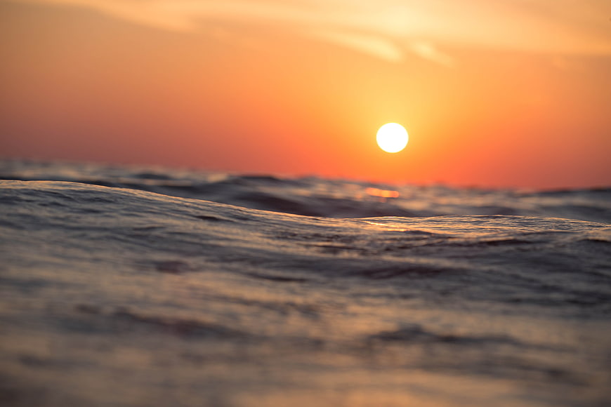Sunset over ocean waves with shallow depth of field